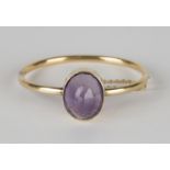 A gold and amethyst oval hinged bangle, the front mounted with an oval amethyst, on a snap clasp,