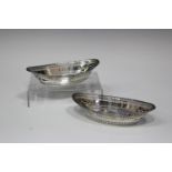 A pair of Edwardian silver oval bonbon dishes, each with pierced sides and beaded rim, London 1904