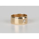 An 18ct gold and diamond single stone band ring, star gypsy set with a cushion cut diamond, London
