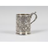 A George IV silver christening mug, the cylindrical body decorated with fruiting vines, flanked by a