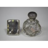 An Edwardian silver mounted cut glass scent bottle, the globular body with facet and diamond cut