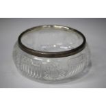 A George V silver mounted cut glass fruit bowl, the silver rim with bead and reel decoration,