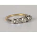 A gold and diamond five stone ring, claw set with a row of cushion cut diamonds graduating in size