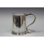 A George I Britannia standard silver tankard, the gently tapered cylindrical body with scroll