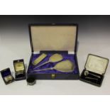 A small group of silver items, including an Elizabeth II four-piece dressing table set with reeded