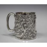 A late Victorian silver christening cup, gilt lined and with embossed floral and scroll