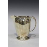 A George VI silver cream jug, the ovoid body raised on a stepped circular foot, Sheffield 1937 by