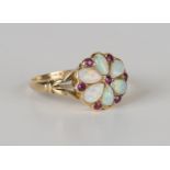 A gold, opal and ruby cluster ring, mounted with six opals and seven small cushion cut rubies at