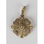 A gold and seed pearl pendant, circa 1910, in a heart shaped quatrefoil design, detailed '15ct',