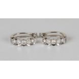 A pair of 18ct white gold and diamond earclips, each mounted with a row of five circular cut