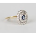 A gold, sapphire and diamond oval cluster ring, collet set with an oval cut sapphire within a two