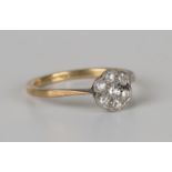 A gold and diamond seven stone cluster ring, mounted with cushion cut diamonds, detailed '18ct',