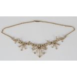 A gold and half-pearl pendant necklace, the front formed as graduated floral and foliate scroll