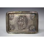 A late Victorian silver rectangular dressing table tray, embossed and engraved with a reclining