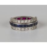 A diamond, synthetic ruby and synthetic sapphire swing-over eternity ring, mounted with circular cut