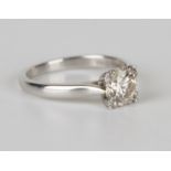 A platinum and diamond single stone ring, claw set with a circular cut diamond, ring size approx