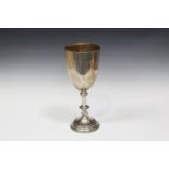 A large late Victorian silver goblet, the U-shaped body presentation inscribed above a beaded knop