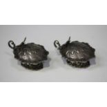 A pair of 20th century Spanish silver shell shaped salts, each hinged lid with bird finial above a