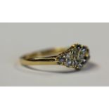 A gold and diamond cluster ring, mounted with cushion cut diamonds, detailed '18ct', ring size