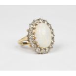 A gold, opal and diamond oval cluster ring, claw set with an oval opal within a surround of circular