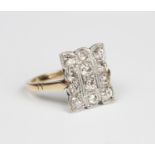 A gold and diamond panel shaped rectangular cluster ring, mounted with twelve cushion cut