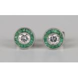 A pair of white gold, diamond and emerald circular cluster earrings, each collet set with a circular