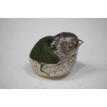 A George V silver novelty pin cushion in the form of a chick emerging from an egg, London 1923 by