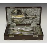 A George V silver four-piece dressing table set, engraved with tied ribbon bows amongst foliate