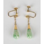 A pair of gold and jade pendant earrings, each mounted with a drop shaped jade, with screw fittings,