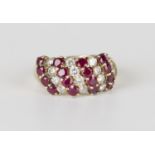 A gold, ruby and diamond ring, claw set with four rows of four circular cut rubies alternating