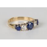 A gold, sapphire and diamond five stone ring, claw set with a row of three circular cut sapphires