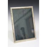 A sterling mounted rectangular photograph frame, detailed 'Sterling', height 34.3cm.Buyer’s