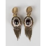 A pair of gold, carbuncle garnet and white enamelled earclips, the principal oval drops and