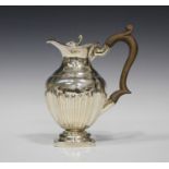 A late Victorian silver hot water pot of half-reeded form, Chester 1897 by George Nathan & Ridley