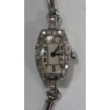 A platinum and diamond lady's dress wristwatch with jewelled lever movement, the silvered dial