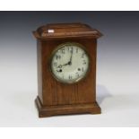 An early 20th century American oak cased mantel clock, striking on a gong, the case with moulded