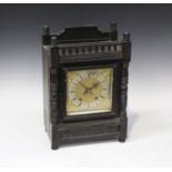 A late 19th century German ebonized walnut mantel clock with eight day movement striking on a