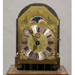 A 20th century Dutch walnut longcase clock with three train movement striking on gongs, the brass