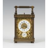 A late 19th/early 20th century French brass cased carriage alarm clock, the eight day movement