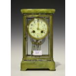 An early 20th century French brass, onyx and champlevé enamel four glass mantel clock with eight day