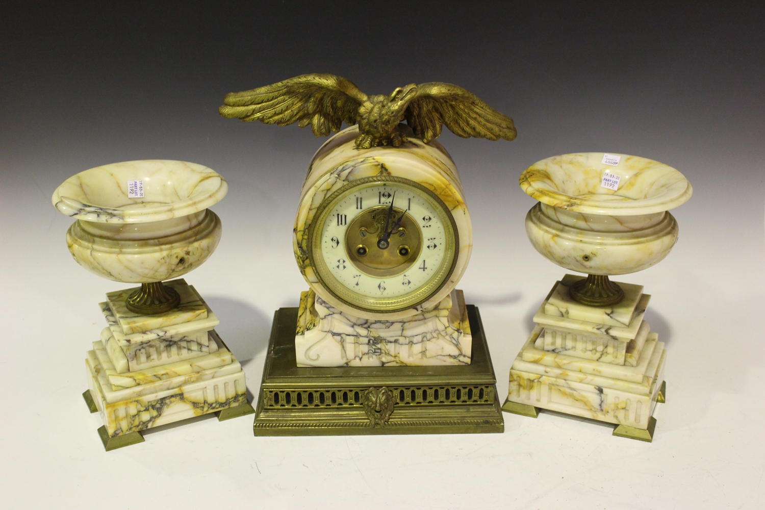 A late 19th century French marble and brass clock garniture, the drum cased clock with eight day