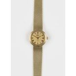A Mido gold lady's bracelet wristwatch, the signed gilt dial with black Roman numerals, on a