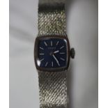 A Tissot 9ct white gold lady's bracelet wristwatch, the curved square blue dial with baton hour