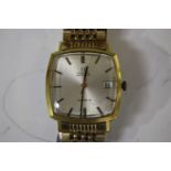 An Omega Automatic gilt metal fronted and steel backed gentleman's bracelet wristwatch, the curved