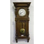 A late 19th century walnut Vienna wall clock by Gustav Becker, the eight day movement striking on