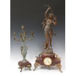 An early 20th century spelter and rouge marble mantel clock with eight day movement striking on a