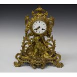 A late 19th century French gilt metal mantel clock with eight day movement striking on a bell via an