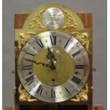 A 20th century oak longcase clock with eight day three train movement chiming on gongs, the brass