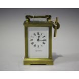 A 20th century brass carriage timepiece, the enamel dial with Roman hour numerals and inscribed '