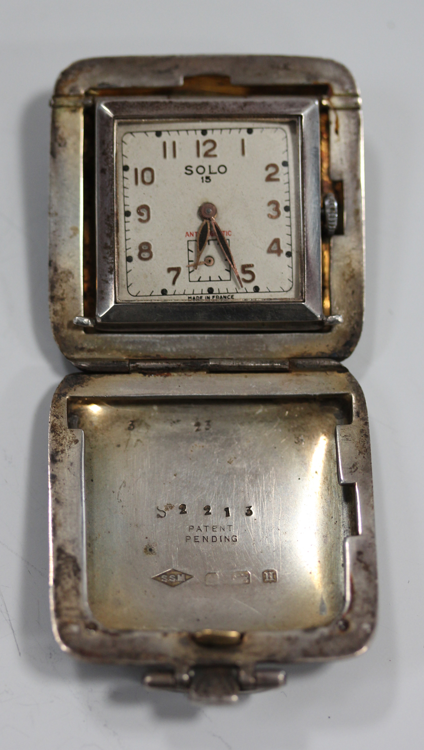 A Solo 15 silver square cased travelling watch, the signed silvered dial with gilt Arabic numerals - Image 3 of 4